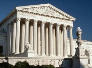The exterior of the U.S. Supreme Court building with white stone columns and a white facade.