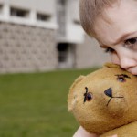 Boy with Black Eye Hugging Teddy Bear --- Image by © Guntmar Fritz/zefa/Corbis