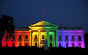 A photo of the White House with rainbow lights shown on it