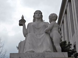 Statue entitled "The Spirit of Justice" outside of the Rayburn Huse Office Building in Washington, D.C., showing a seated woman with a small child.