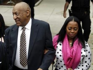 Bill Cosby and Keisha Knight Pullman walk together outside of the courtroom where he faced trial on charges of rape.