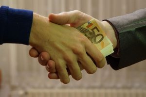 Shaking hands with hidden money