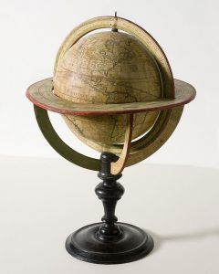 Potograph of an antique globe of the world showing the continents and nations circa the 1800s.