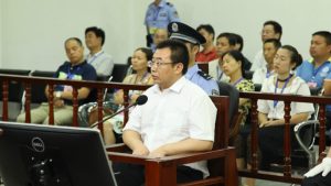Chinese lawyer Jiang Tianyong sits in front of a microphone during his trial.