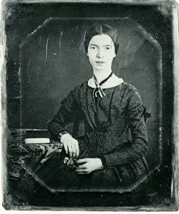 Daguerreotype showing a young Emily Dickinson seated at a table taken at Mount Holyoke Seminary in December 1847 or early 1848