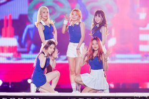The Korean pop music group Red Velvet, consisting of five women wearing blue and white outfits, pose on a stage in Inchon, South Korea.