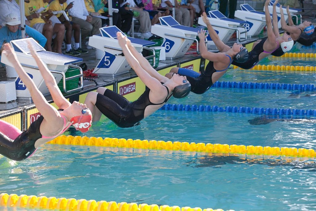 Swimmers beginning a backstroke race