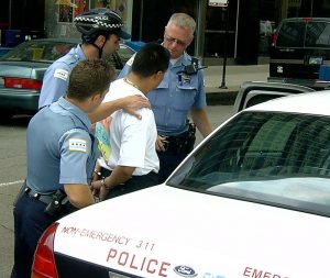 A man being arrested by the Chicago police department.