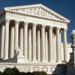 The exterior of the U.S. Supreme Court building with white stone columns and a white facade.