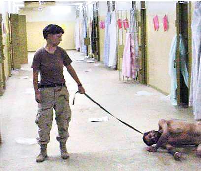 A woman with a man in Abu Ghraib