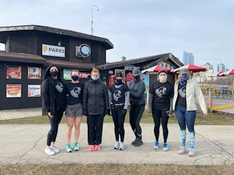 group of women in running clothes standing outside in the cold