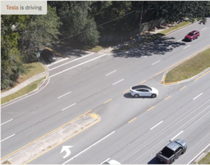 Aerial photo of Tesla car in Full Self Driving mode making a left turn