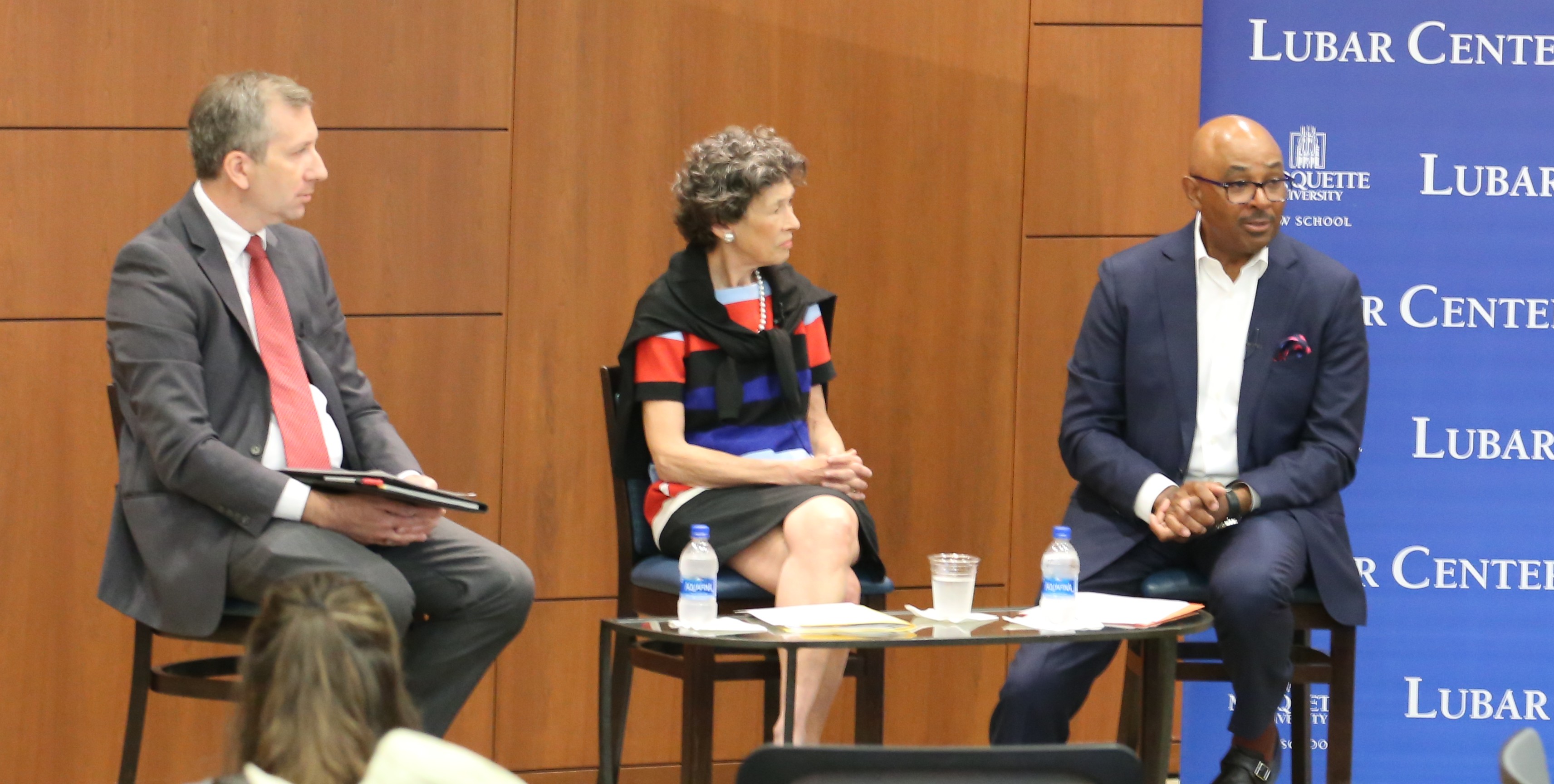 Three people conversing at a water law event
