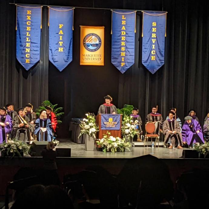 Stage party at graduation where Dean Kearney is speaking. 