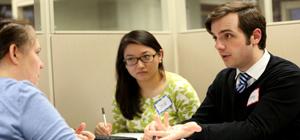 Two students helping a person